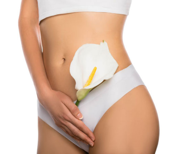 woman dressed in white panties holding a white flower in her hands close up 1